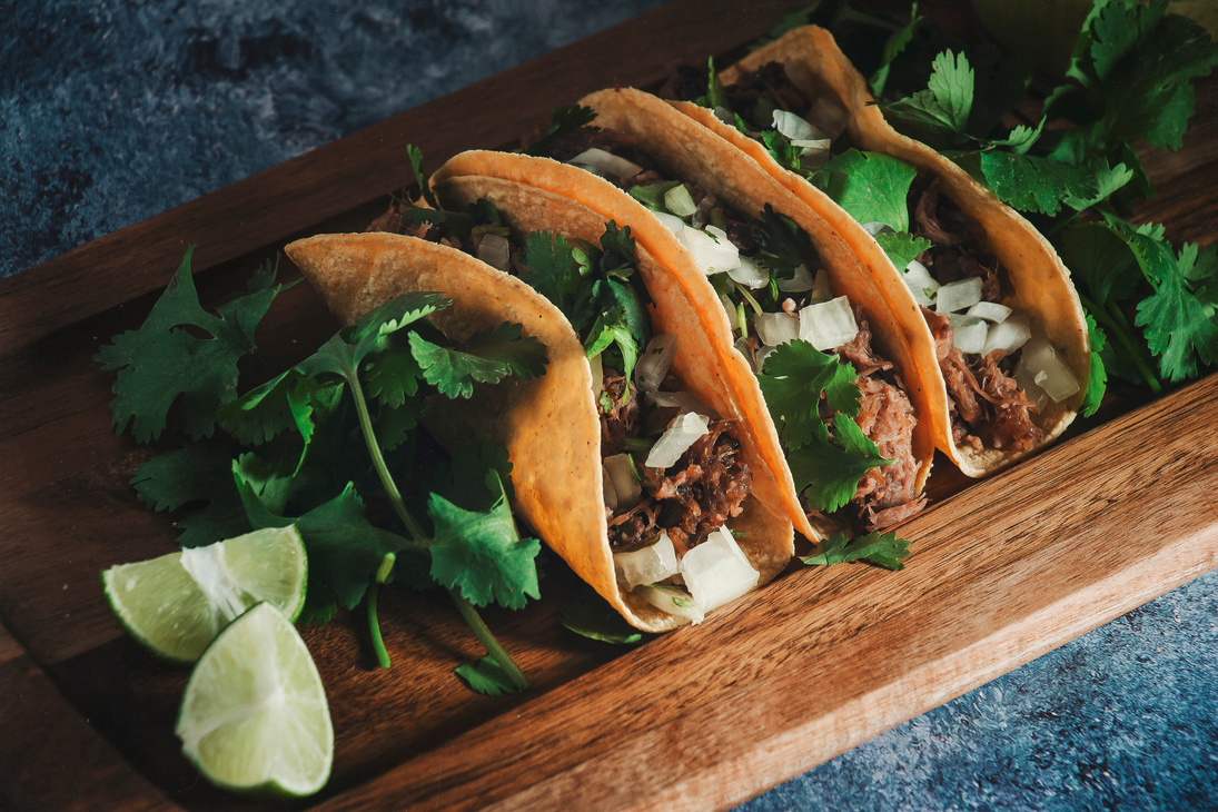 Mexican Tacos of Barbecue with Coriander and Limes on Wood Tray